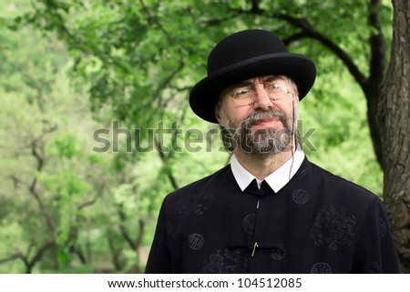 Similar – Man in tails with bouquet and top hat looks into camera