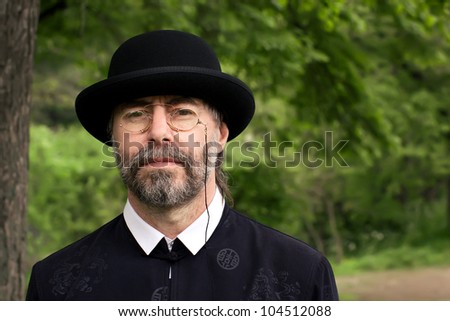 Similar – Man in tails with bouquet and top hat looks into camera