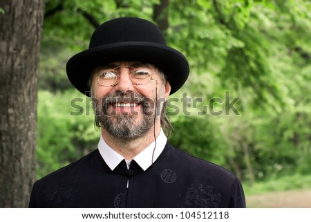 Similar – Man in tails with bouquet and top hat looks into camera