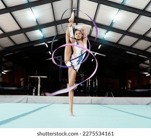 Portrait, ribbon and dance with a gymnastics woman in a studio for training, exercise or dancing. Fitness, art and gymnast with a female dancer in a gymnasium for rhythmic routine practice - Powered by Shutterstock