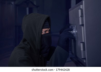 Portrait Of A Robber Trying To Open A Safety Box