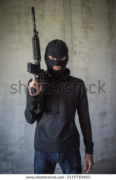 Portrait robbery man standing is holding M16 gun\
on hand, kidnapping Thief\
robber