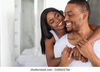 Portrait Of Romantic African American Couple Embracing In Bathroom In The Morning, Happy Black Millennial Spouses Bonding While Getting Ready At Home Together, Smiling To Each Other, Closeup - Powered by Shutterstock