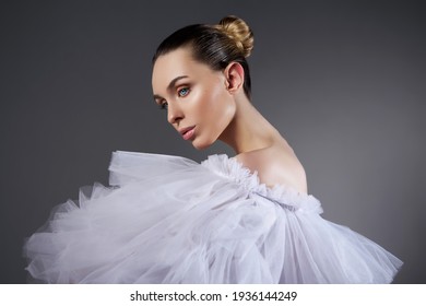 Portrait Of A Romantic Beauty Woman In Light Dress. Natural Cosmetics, Beautiful Smooth Facial Skin, Hair Pulled Back In A Bun, Art Body