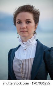 Portrait Of Romantic Young Beautiful Lady Wearing Victorian Dress Looking  At The Sea. Vintage Style. Steampunk Concept