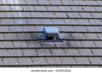 A Portrait Of A Roof Vent On A Slate Roof On A House. This Small Chimney Like Object Is Used As A Ventilation, To Ventilate A House And Regulate The Air Flow Or Air Supply Of A Building.