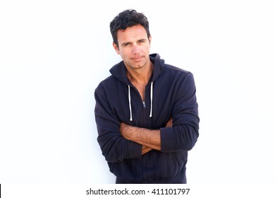 Portrait Of A Rugged Handsome Middle Aged Man Standing With Arms Crossed Against White Background