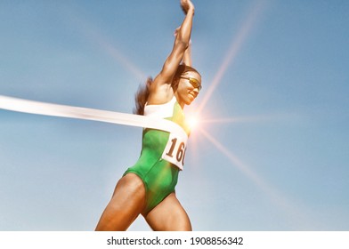 Portrait of Runner Breaking Finish Line Tape - Powered by Shutterstock