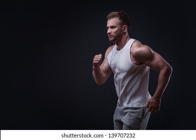 Portrait Of Running Man Isolated On Black Background