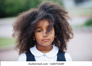 Portrait Of A Sad African American Girl On A Sunny Summer Day Outdoors.