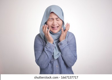 Portrait of sad Asian muslim woman wearing hijab crying, depression concept