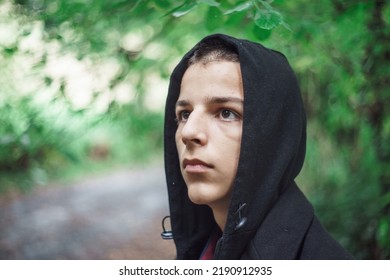 Portrait Of A Sad Boy Outside In Nature