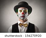 portrait of sad clown with bowler hat and red nose