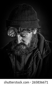 Portrait Of Sad Coal Miner With Beard Looking Down