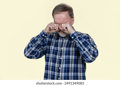 Portrait of sad crying aged senior man wiping his tears. Isolated on white background. - Powered by Shutterstock