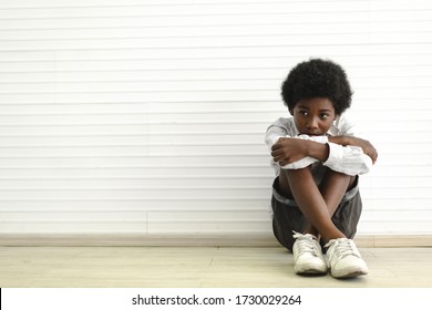 Portrait Of Sad Depressed Black African American Cute Little Boy Child  Alone Sitting On Floor At Home