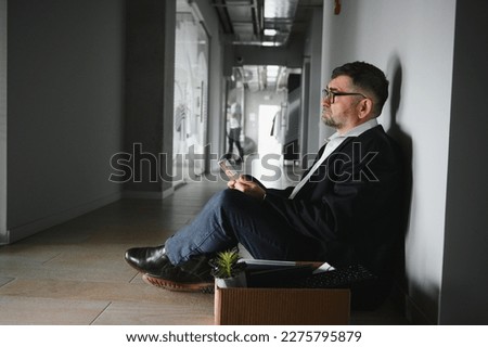 Portrait of sad dismissed senior old business man worker taking his office supplies in the box. Pensioner mature retire from work carry staff back home. Lifestyle business retirement, quit job concept Foto d'archivio © 
