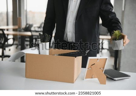 Portrait of sad dismissed senior old business man worker taking his office supplies in the box. Pensioner mature retire from work carry staff back home. Lifestyle business retirement, quit job concept