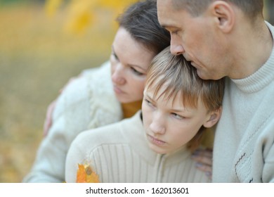 Portrait Of A Sad Family Of Three On The Nature