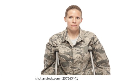 Portrait Of Sad Female Airman On Crutches