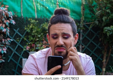 Portrait Of Sad Gay Man With Beard With Mobile. LGBT People Discrimination