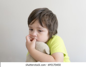 kid hugging teddy bear