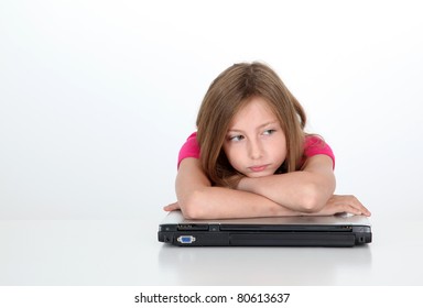 Portrait Of Sad Little Girl With Laptop Computer