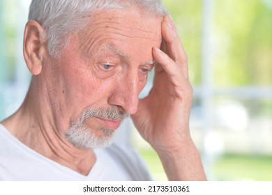 Portrait Of Sad Pensive Senior Man Posing At Home