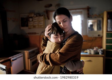Portrait of sad poor mature mother hugging small daughter indoors at home, poverty concept. - Powered by Shutterstock