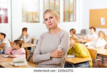 Portrait Of Sad School Teacher Who Is Standing Dissatisfied After Lecture In The Classroom