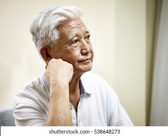 Portrait Of Sad Senior Asian Man Hand On Chin, Side View.