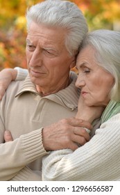 Portrait Of Sad Senior Couple In Park