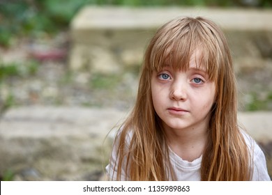 Portrait Of Sad Vulnerable Little Girl In Dirty Alley, Shallow Depth Of Field.