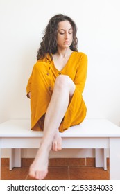 Portrait Of A Sad Woman In A Yellow Dress, Pensive Brunette, Sad Mood, Melancholy, Girl In A White Room