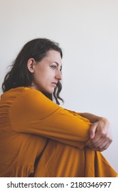 Portrait Of A Sad Woman In A Yellow Dress, Pensive Brunette, Sad Mood, Melancholy, Girl In A White Room