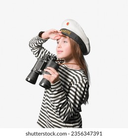 Portrait of a sailor girl on a white background teenage girl in a sailor suit with a binocular looking into the distance.