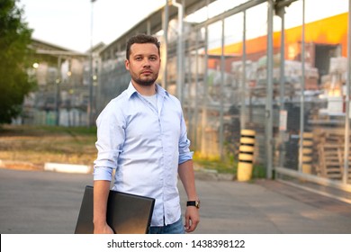 Portrait Of Sales Representative. Logistics Manager Waiting His Business Partner To Have A Deal. Concept Of Warehouse Outdoor And Transportation Services. 
