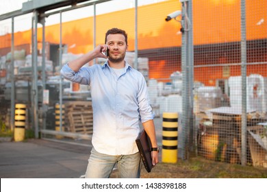 Portrait Of Sales Representative. Logistics Manager Calling To His Business Partner To Have A Deal. Concept Of Warehouse Outdoor And Transportation Services. 
