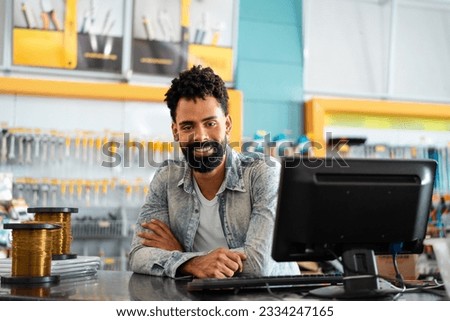Portrait of salesman. Happy Professional Shop assistant of retail store at counter with big smile in home improvement retail