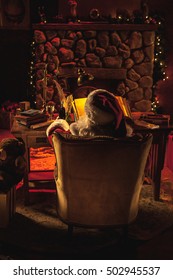 A portrait of Santa Claus from behind as he works in his workshop at the north [ole 