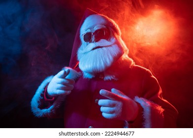 Portrait of Santa Claus in sunglasses in neon light. - Powered by Shutterstock