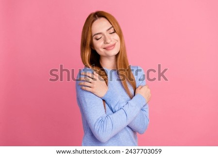 Portrait of satisfied adorable girl with foxy hairdo wear blue pullover hug herself enjoy fresh clothes isolated on pink color background