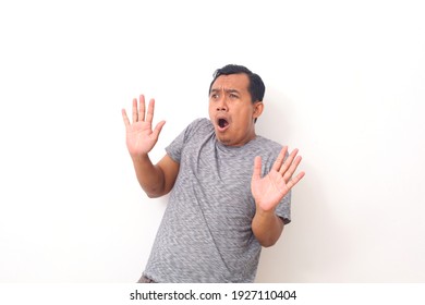 Portrait Of Scared Asian Man Isolated Over White.