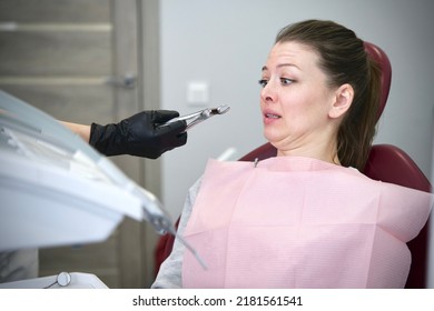 Portrait Of Scared Horrified Frightened  Girl Patient With Dentist Phobia, Young Woman In Panic Is Crying Afraid Of Stomatologist, Sitting At Dentistry Office In Armchair. Fear Of Doctor, Pain