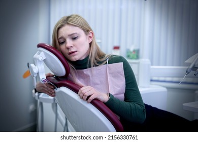 Portrait Of Scared Horrified Frightened Teen Girl Patient With Dentist Phobia, Young Woman In Panic Is Crying Afraid Of Stomatologist, Sitting At Dentistry Office In Armchair. Fear Of Doctor, Pain