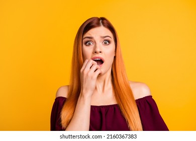 Portrait of scared unsatisfied negative girl hand near mouth stare isolated on yellow color background