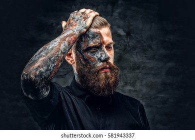 Portrait of a scary bearded male with burning make.