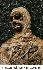 Portrait of scary evil mummy on green dark background. Halloween. Ancient Egyptian mythology.