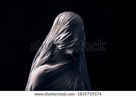 Similar – Image, Stock Photo Portrait of a gothic rocker-looking woman, looking directly at the camera, wearing a leather jacket, on plain gray background