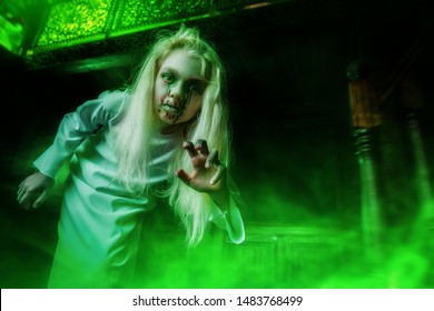 A portrait of a scary pale girl from a horror film in a room. Zombie, halloween.